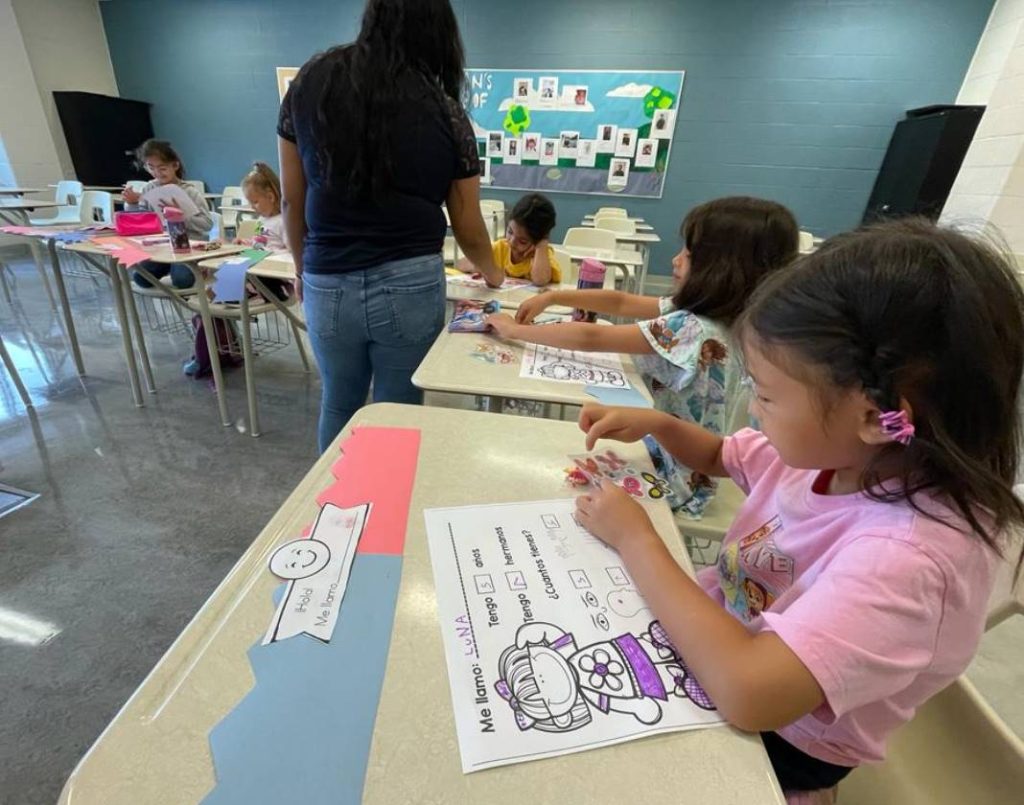 Elementary-aged children working together during Spanish class.