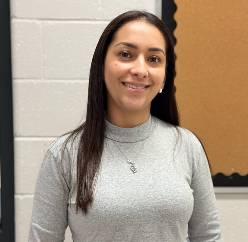 Welcoming Spanish teacher supporting young learners